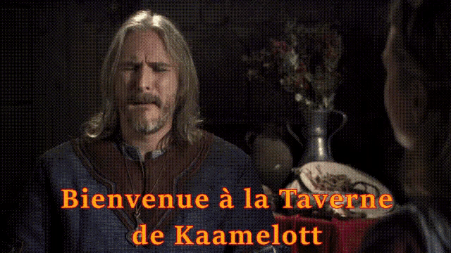 a man and woman are sitting at a table with the words bienvenue a la taverne de kaamelott written above them