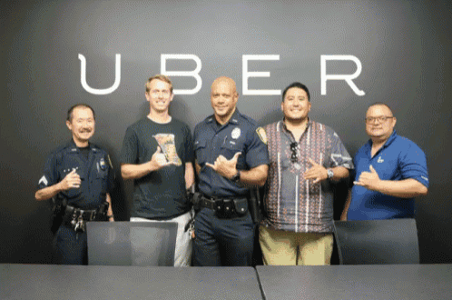 a group of men are posing for a picture in front of a wall that says uber