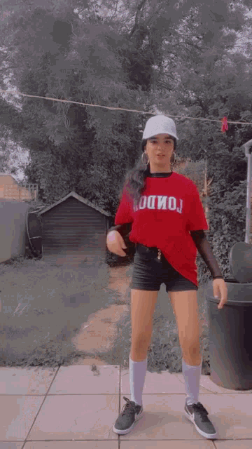 a girl wearing a red t-shirt that says hollywood