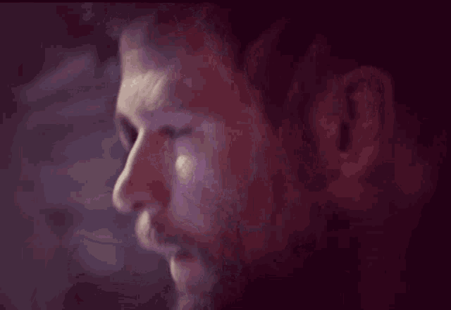 a close up of a man 's face with his eyes closed