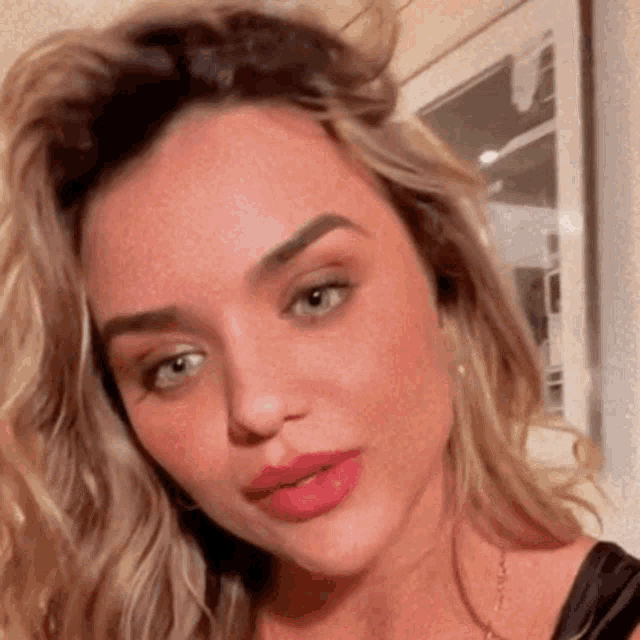 a close up of a woman 's face with blonde hair