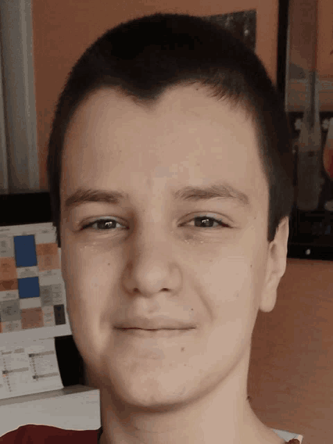 a close up of a young man 's face with a poster in the background that says ' chemistry ' on it