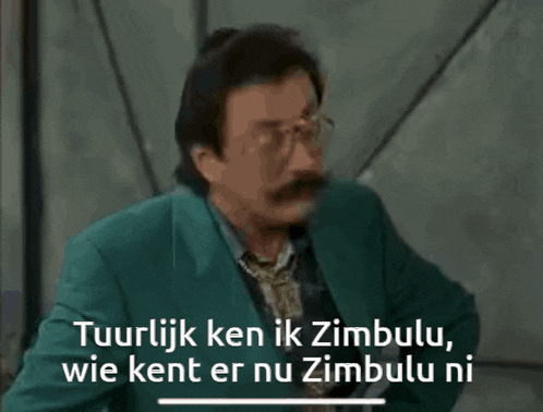 a man with glasses and a mustache is talking in a foreign language