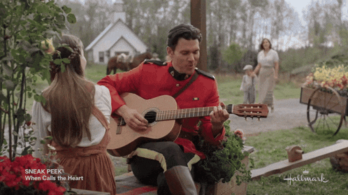 a man in a military uniform is playing a guitar with a little girl behind him