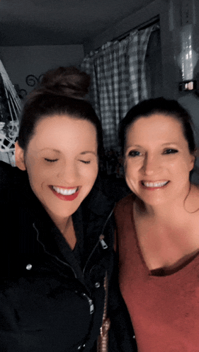 two women are posing for a picture with their eyes closed and smiling