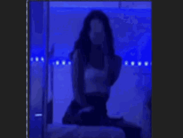 a woman is standing in front of a sign that says o.a.l.k. horny