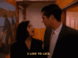 a man and a woman are standing next to each other and the woman is saying i like to lick