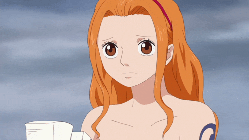 a girl with long orange hair has a tattoo on her arm that says g