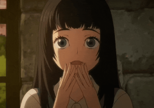 a close up of a girl 's face with her hands folded in front of her face