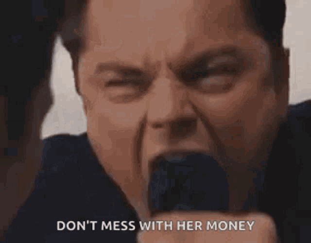 a man in a suit and tie is making a funny face and screaming .