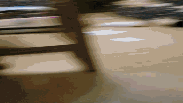 a blurred image of a person walking down a staircase