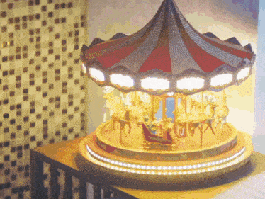 a merry go round with a sleigh in the middle of it