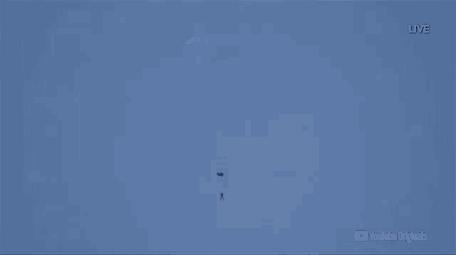 a person is parachuting in a blue sky with the youtube originals logo in the corner
