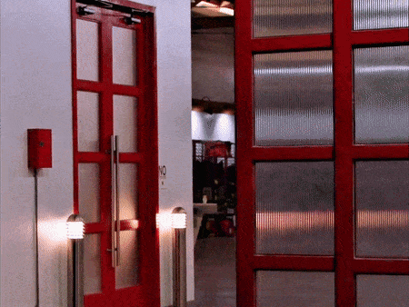 a red door with a no smoking sign on it