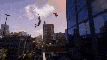 two spidermans are flying through the air in front of a city skyline