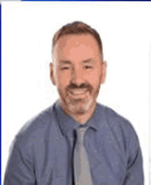 a man in a blue shirt and tie with the words `` im gay '' written above him .
