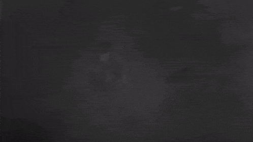 a black and white photo of a cloudy sky with smoke coming out of it .