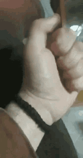 a close up of a person 's hand with a bracelet on their wrist