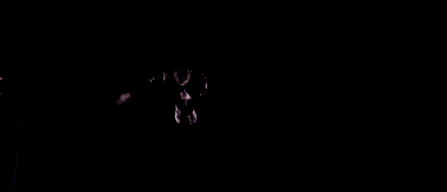 a person is sitting on a set of stairs surrounded by lines of lights