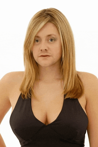 a woman with blonde hair is wearing a black tank top with a plunging neckline
