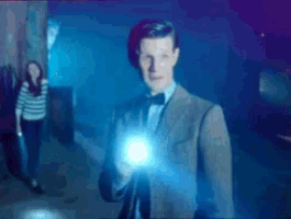 a man in a suit and bow tie is holding a light