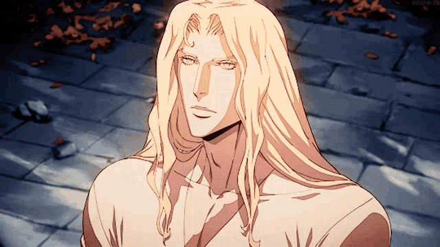 a man with long blonde hair is standing on a brick sidewalk