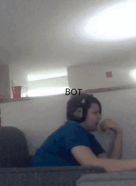 a person wearing headphones with the word bot written above them