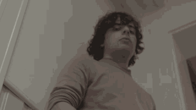 a man is pointing at the camera with the name tjena written below him