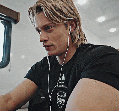 a man wearing ear buds and a labrum t-shirt