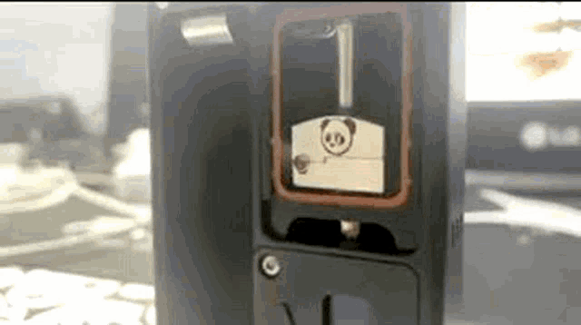 a close up of a device with a panda on the front