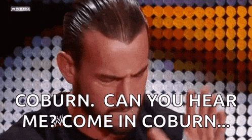 a man in a black shirt is saying coburn can you hear me come in coburn