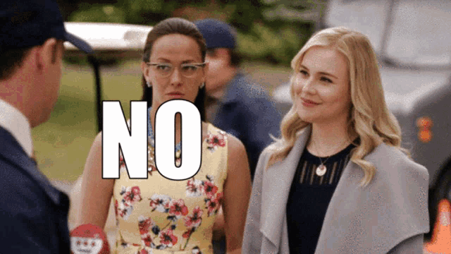 two women are standing next to each other and the word no is visible
