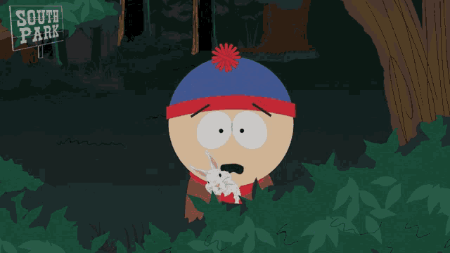 stan marsh from south park is holding a small white rabbit and says jesus christ