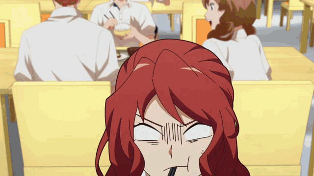 a girl with red hair is making a funny face in a restaurant
