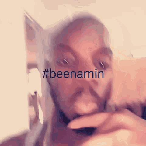 a close up of a person 's face with the words #beenamin written on it