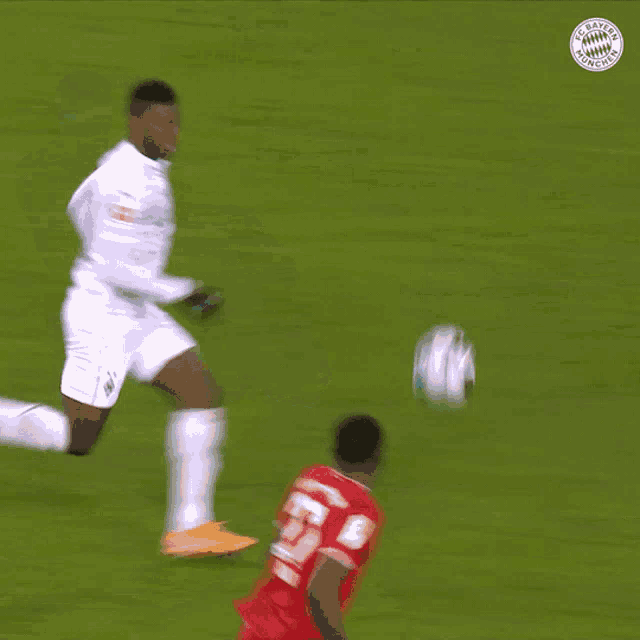 a soccer player with the number 27 on his jersey kicks the ball