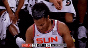 a female basketball player wearing a sun jersey