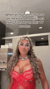 a woman in a red lace top is standing in a public restroom and making a funny face