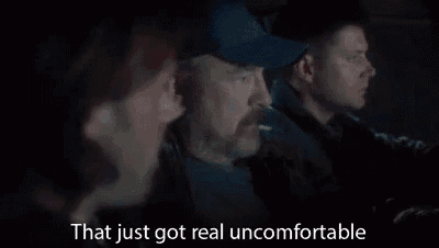 three men are sitting in a car talking to each other .