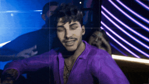 a man in a purple shirt with his eyes closed