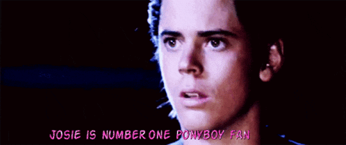a close up of a young man 's face with the words josie is number one ponyboy fan above him .