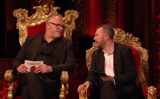 two men are sitting on a throne and one of them is holding a piece of paper that says " tagesaktuelle " on it