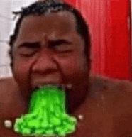 a man is vomiting green liquid from his mouth in a bathroom .