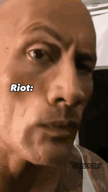 a close up of a man 's face with the words riot written on it