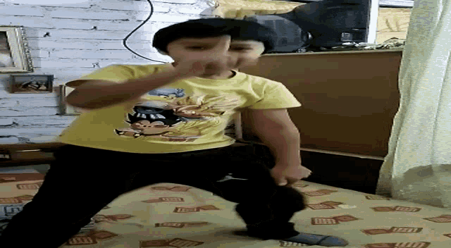 a boy wearing a yellow shirt with a mickey mouse on it