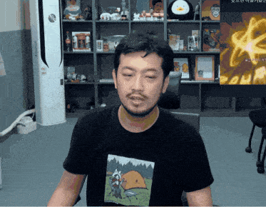 a man wearing a t-shirt with a picture of a tent on it