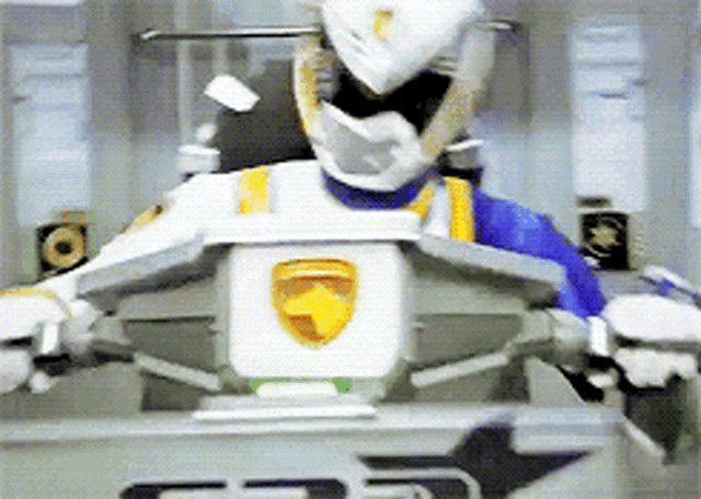 a robot with a helmet on is sitting in front of a sign that says cp