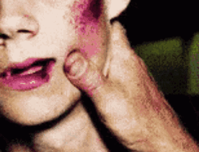 a close up of a person 's face with a pink lip
