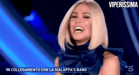 a woman in a blue dress is laughing with the words viperissima in the corner