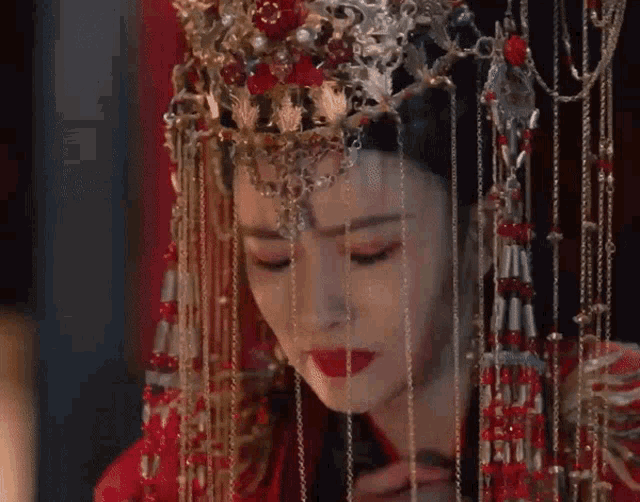 a woman wearing a red dress and a gold crown